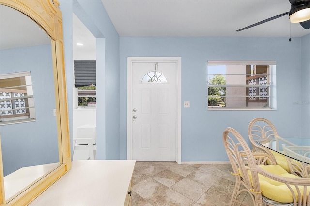 foyer entrance with ceiling fan