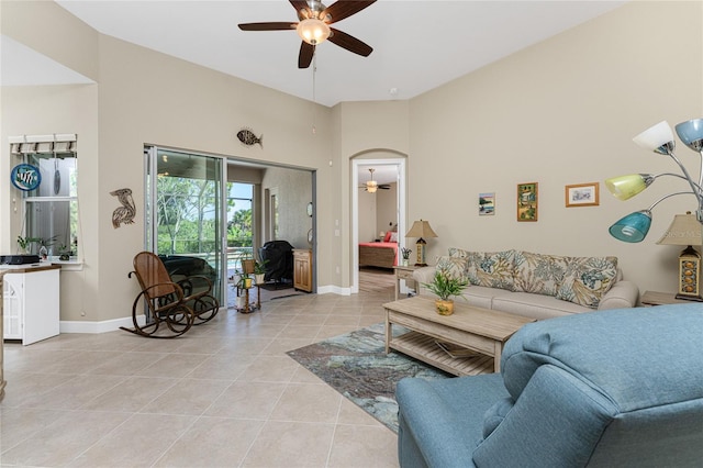 tiled living room with ceiling fan