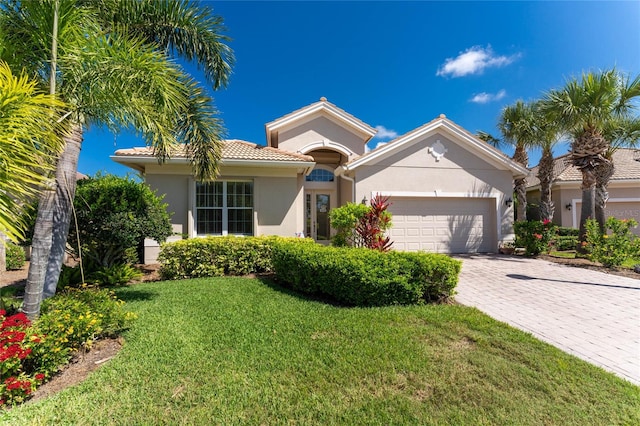 view of front of house with a garage and a front lawn