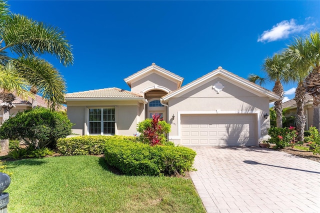 view of front of house with a garage and a front yard