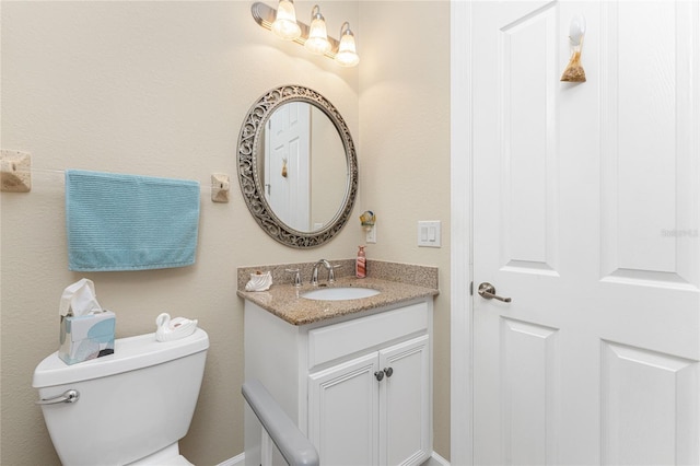 bathroom with toilet and vanity