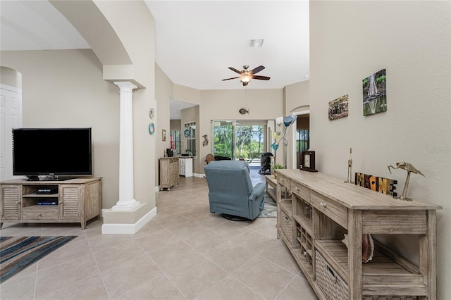 living room with ceiling fan, light tile patterned floors, and ornate columns