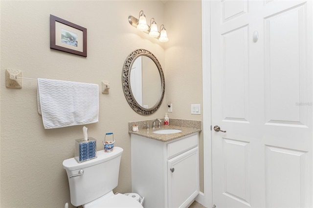 bathroom with toilet and vanity