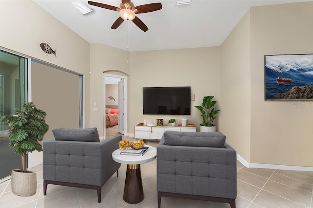 tiled living room featuring ceiling fan