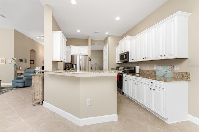 kitchen with light stone countertops, white cabinets, stainless steel appliances, kitchen peninsula, and light tile patterned floors