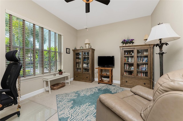 interior space featuring ceiling fan, light colored carpet, and lofted ceiling