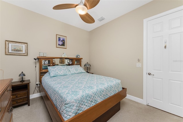 bedroom with ceiling fan and light carpet