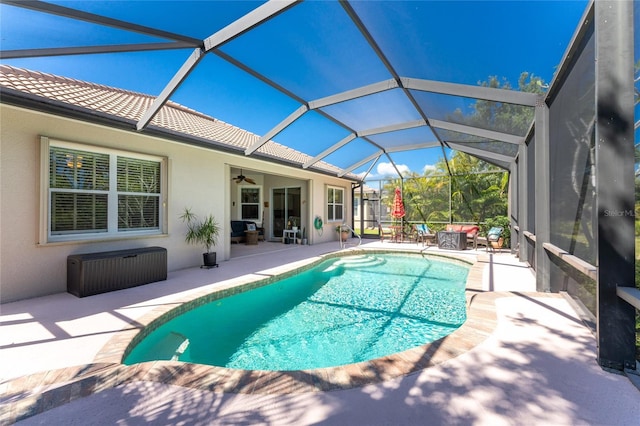 view of pool featuring ceiling fan, a lanai, and a patio