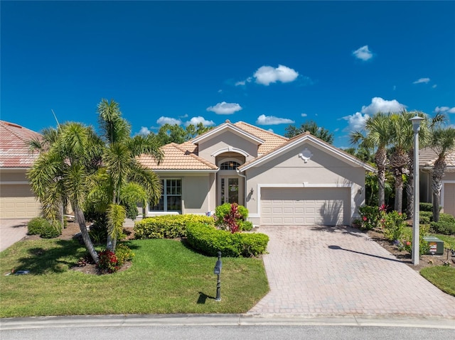 view of front of house with a garage and a front yard