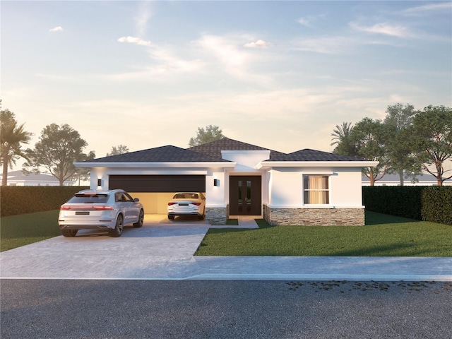 prairie-style house featuring a yard and a garage