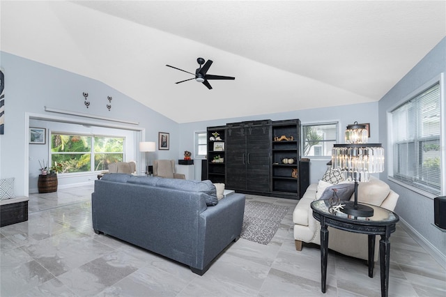 living room featuring ceiling fan with notable chandelier and lofted ceiling