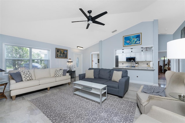 living area featuring visible vents, high vaulted ceiling, and a ceiling fan