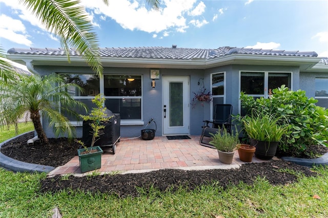 property entrance featuring a patio area