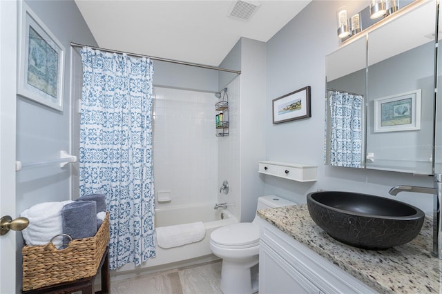 full bathroom with shower / bath combo, toilet, and vanity