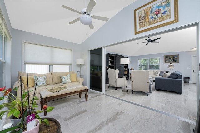 living room with ceiling fan and high vaulted ceiling