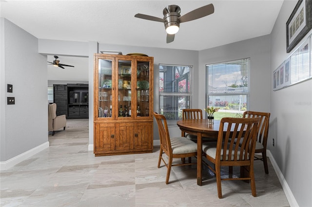 dining room with ceiling fan and a wealth of natural light