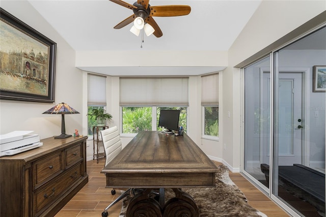 office area featuring ceiling fan, lofted ceiling, and light wood-type flooring