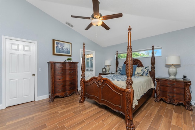 bedroom featuring ceiling fan, light hardwood / wood-style floors, lofted ceiling, and connected bathroom