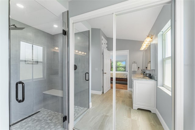 bathroom with vanity and a shower with shower door