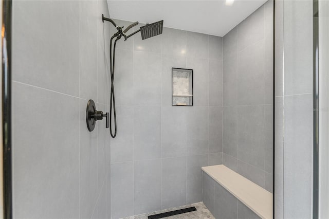 bathroom with a tile shower