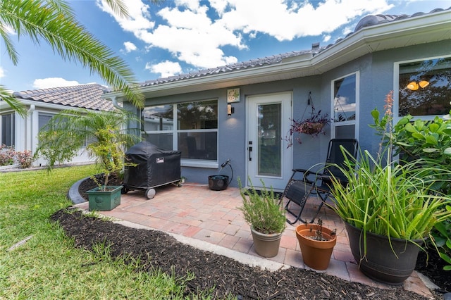 entrance to property featuring a patio area