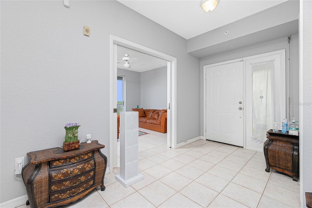 entrance foyer featuring ceiling fan and light tile flooring