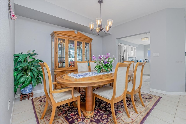 dining room with a notable chandelier and light tile floors