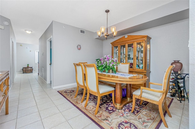 dining room with a chandelier and light tile floors