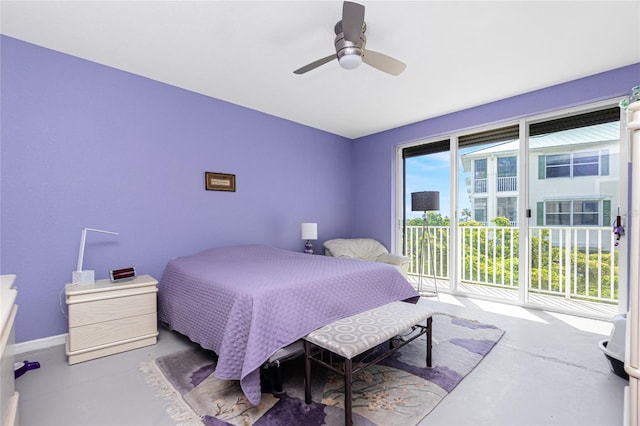 bedroom with ceiling fan, concrete floors, and access to exterior