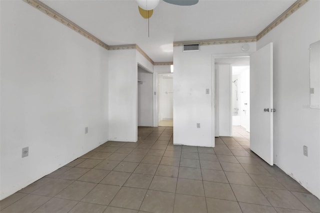 interior space with ceiling fan and tile patterned floors