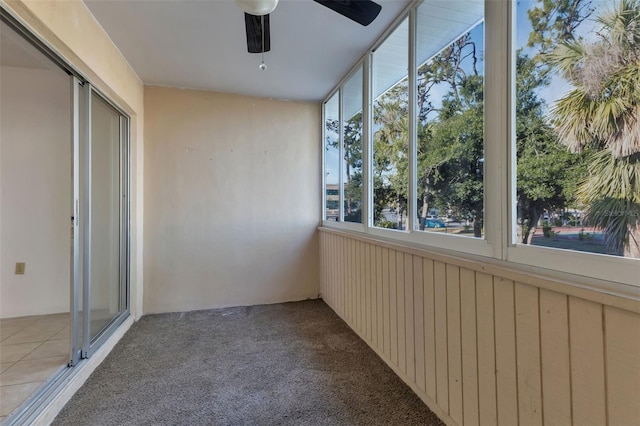 unfurnished sunroom featuring ceiling fan