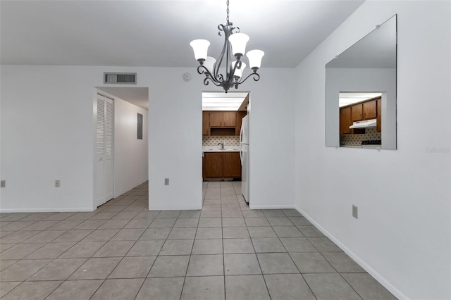 21280 Brinson Ave Unit 214, Port Charlotte, FL 33952 - spare room featuring visible vents, a sink, light tile patterned floors, baseboards, and a notable chandelier