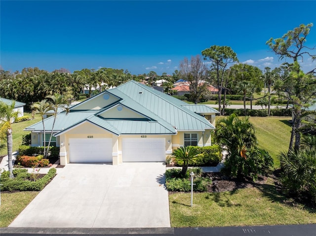 view of front of home featuring a front yard and a garage