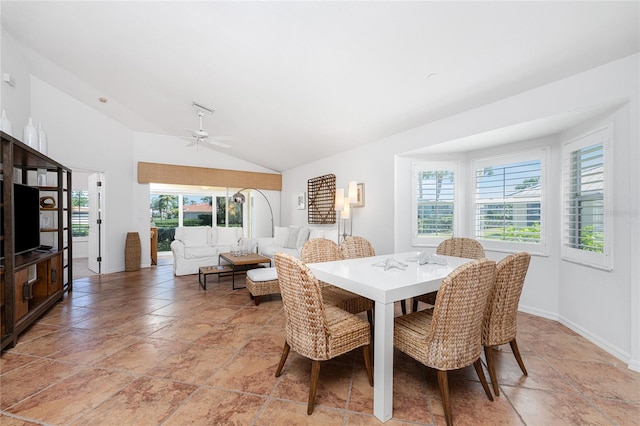 dining space featuring ceiling fan and lofted ceiling