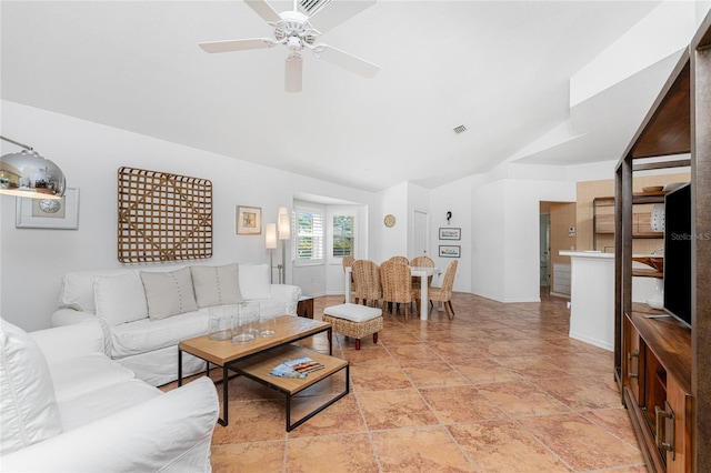 living room with ceiling fan and vaulted ceiling