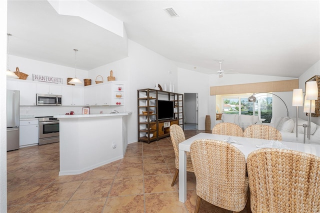 dining room with ceiling fan and lofted ceiling