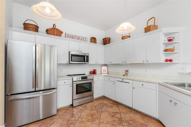 kitchen featuring decorative backsplash, white cabinets, stainless steel appliances, and decorative light fixtures