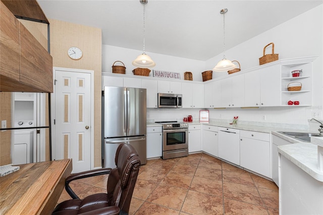 kitchen featuring white cabinets, appliances with stainless steel finishes, decorative light fixtures, and sink