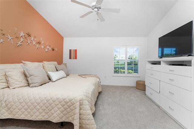 bedroom with light colored carpet, vaulted ceiling, and ceiling fan