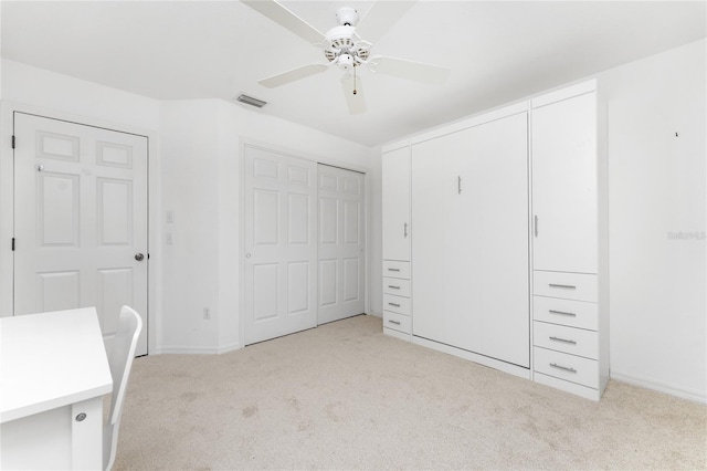 unfurnished bedroom with ceiling fan and light colored carpet