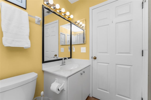 bathroom with vanity and toilet