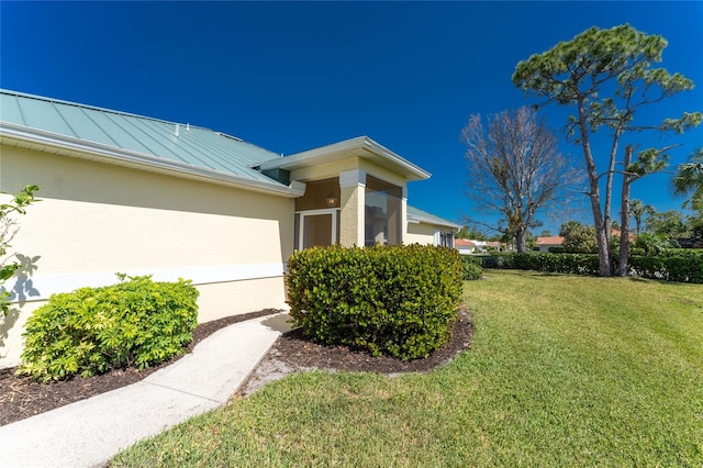 view of property exterior with a lawn