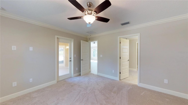 unfurnished bedroom featuring light colored carpet, ceiling fan, and crown molding