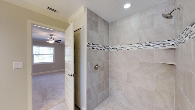 bathroom with ceiling fan, crown molding, tiled shower, and tile flooring