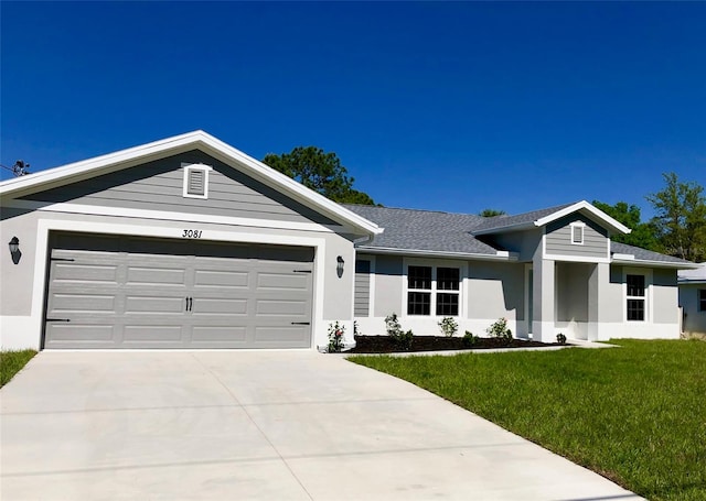 ranch-style house with a front lawn and a garage