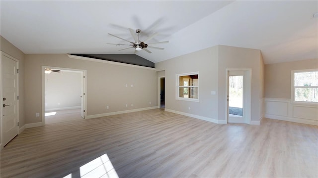 spare room featuring ceiling fan, vaulted ceiling, and light wood-type flooring