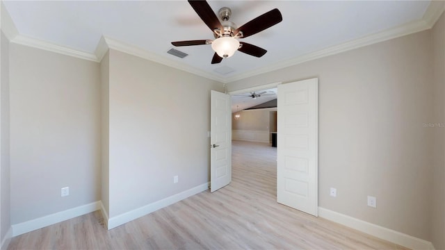 empty room with ornamental molding, ceiling fan, and light hardwood / wood-style flooring