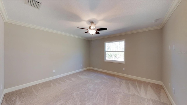 carpeted empty room with ornamental molding and ceiling fan