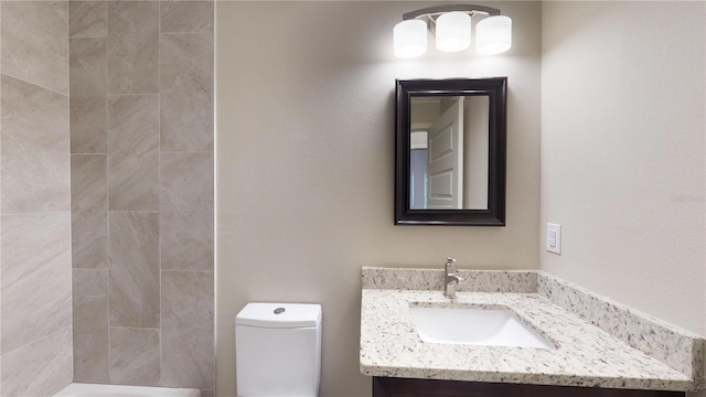 bathroom featuring toilet and vanity