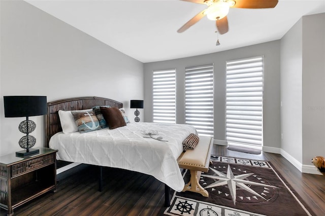 bedroom featuring dark wood-type flooring, ceiling fan, and multiple windows